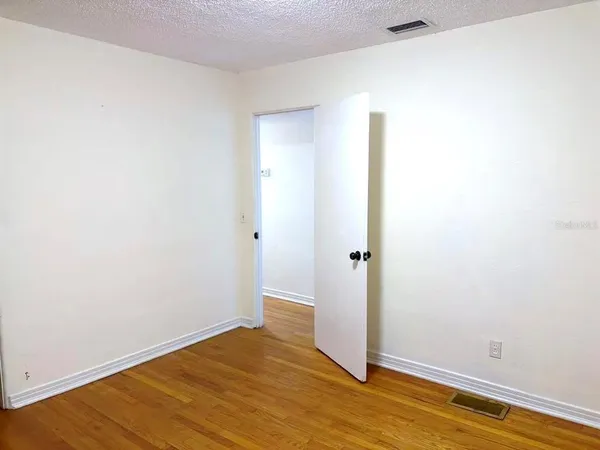 a view of a room with wooden floor