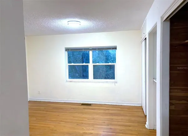 a view of a room with wooden floor and windows