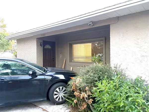 a front view of a house with parking area