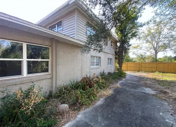a front view of house with yard and trees around