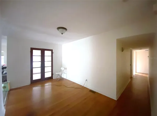 an empty room with windows and closet