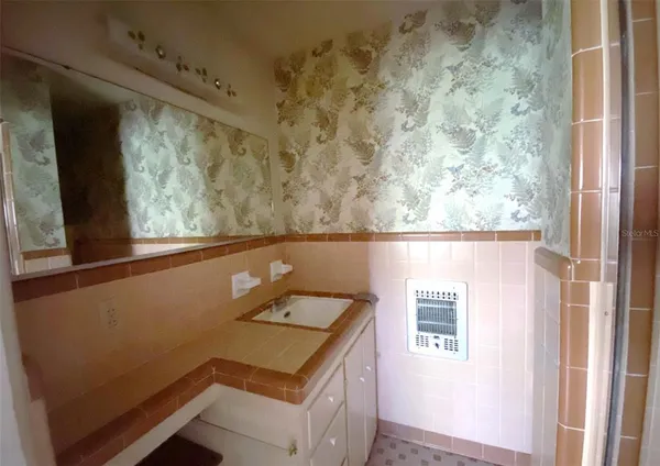 a view of a small space with wooden floor and a window