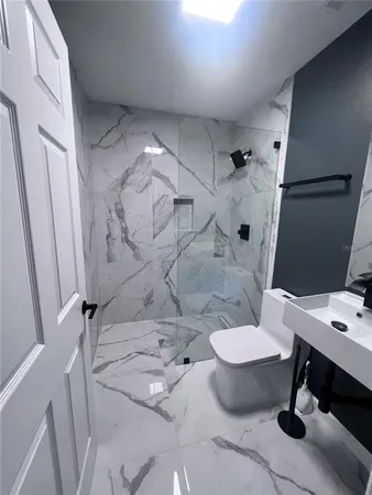 a bathroom with a sink toilet and a mirror