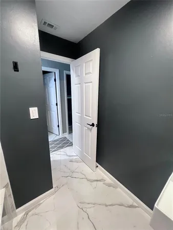 a large bedroom with a large bed and a large window