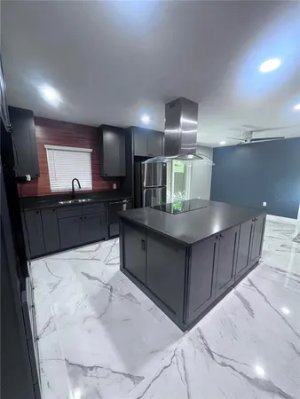 a view of kitchen with refrigerator sink and cabinets