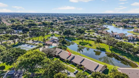 an aerial view of residential houses with outdoor space and swimming pool