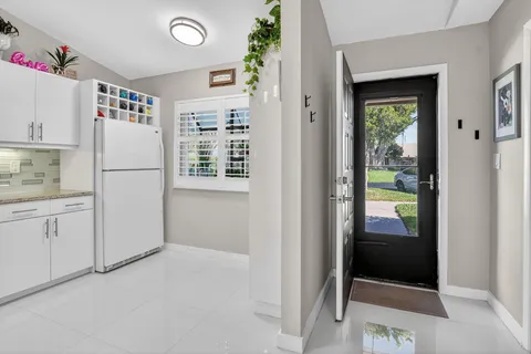 a white refrigerator freezer sitting in a kitchen