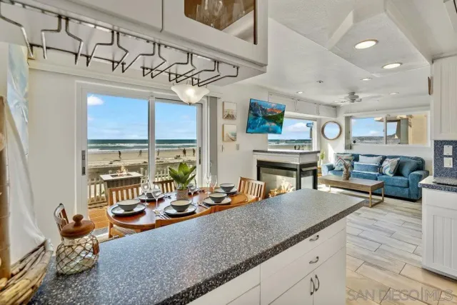 a living room with furniture a fireplace and a dining table