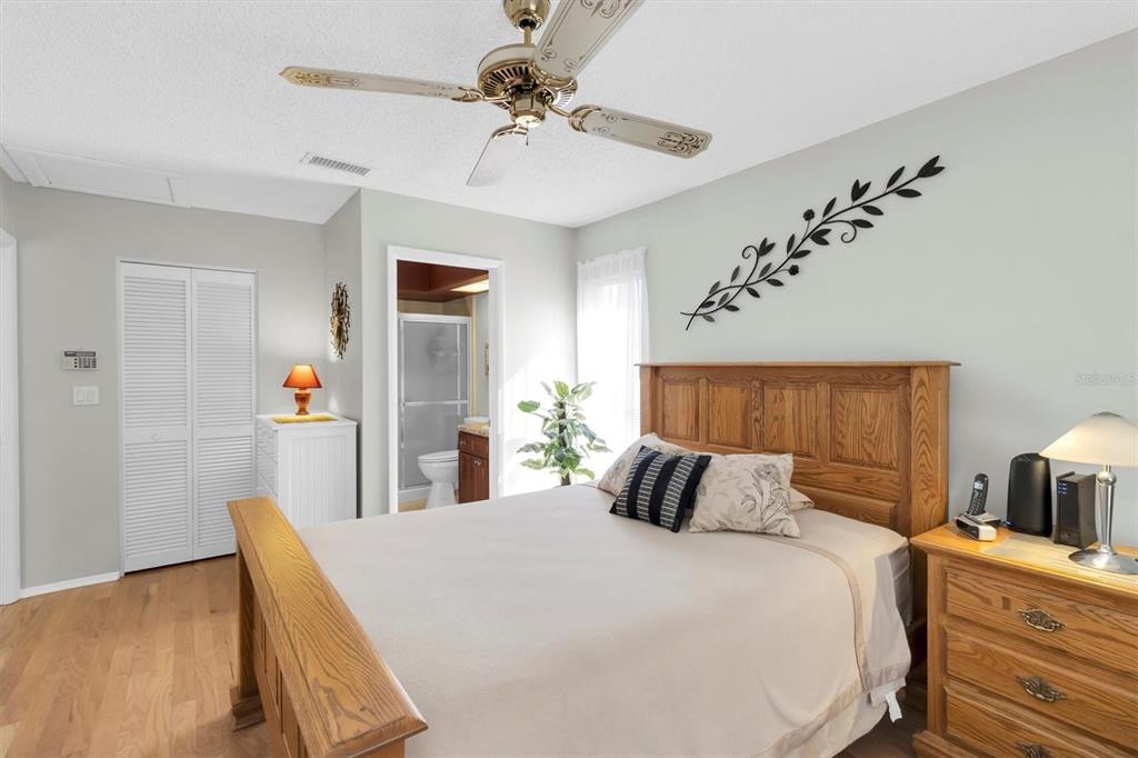 8141 Braddock Circle, Unit 3 Port Richey, FL 34668 - Photo 15 of 59 a bedroom with a bed and a chandelier