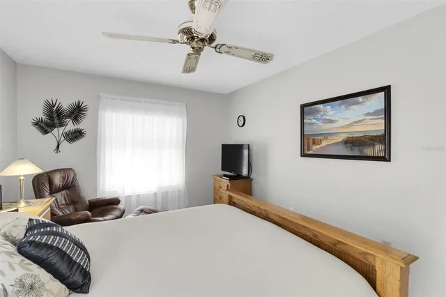 a bedroom with a bed and a night stand