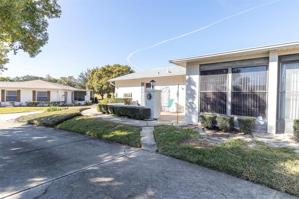 8141 Braddock Circle, Unit 3 Port Richey, FL 34668 - Photo 2 of 59 a view of a house with a yard and large tree