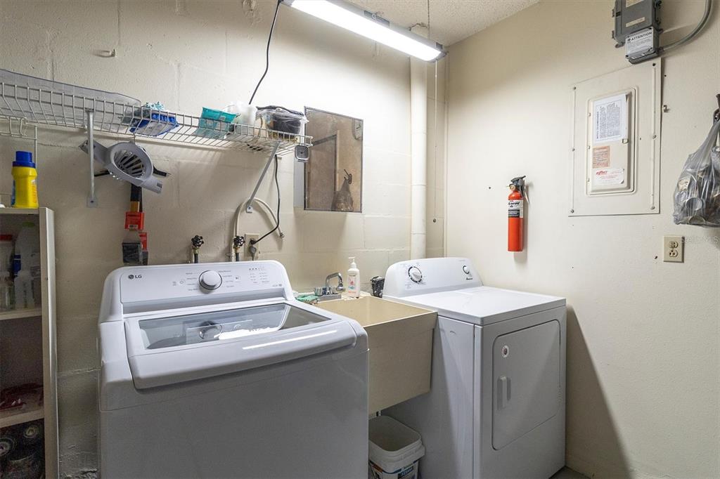 8141 Braddock Circle, Unit 3 Port Richey, FL 34668 - Photo 23 of 59 a utility room with dryer and washer