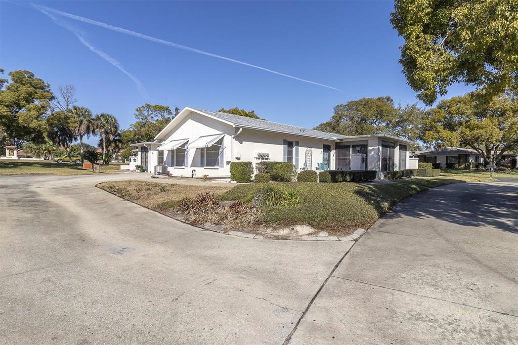 8141 Braddock Circle, Unit 3 Port Richey, FL 34668 - Photo 25 of 59 a front view of a house with a garden