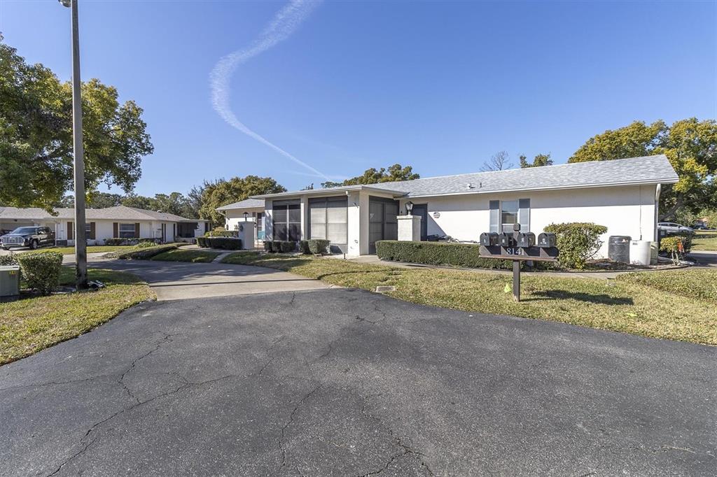 8141 Braddock Circle, Unit 3 Port Richey, FL 34668 - Photo 26 of 59 a view of house with outdoor space and street view