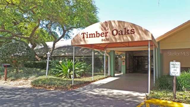 a living room with furniture a lamp and a chandelier