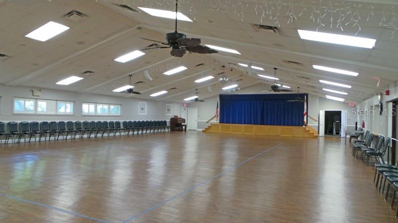 8141 Braddock Circle, Unit 3 Port Richey, FL 34668 - Photo 35 of 59 a view of a room with lots of dining space and wooden floor