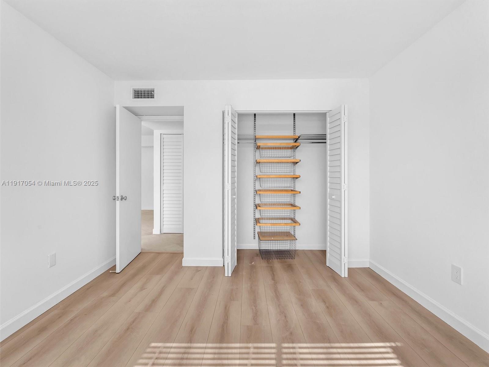 Key Biscayne Key Biscayne, FL 33149 - Photo 13 of 19 a view of empty room with wooden floor