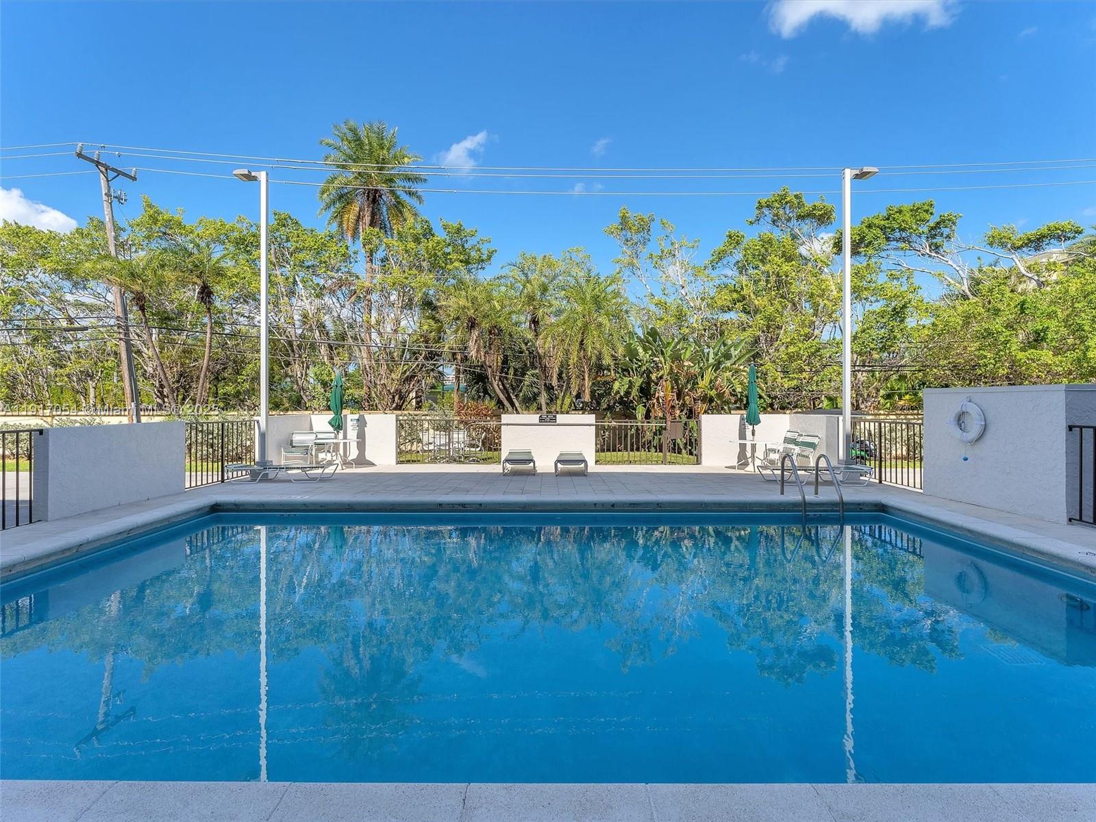 Key Biscayne Key Biscayne, FL 33149 - Photo 18 of 19 a view of a swimming pool with a yard
