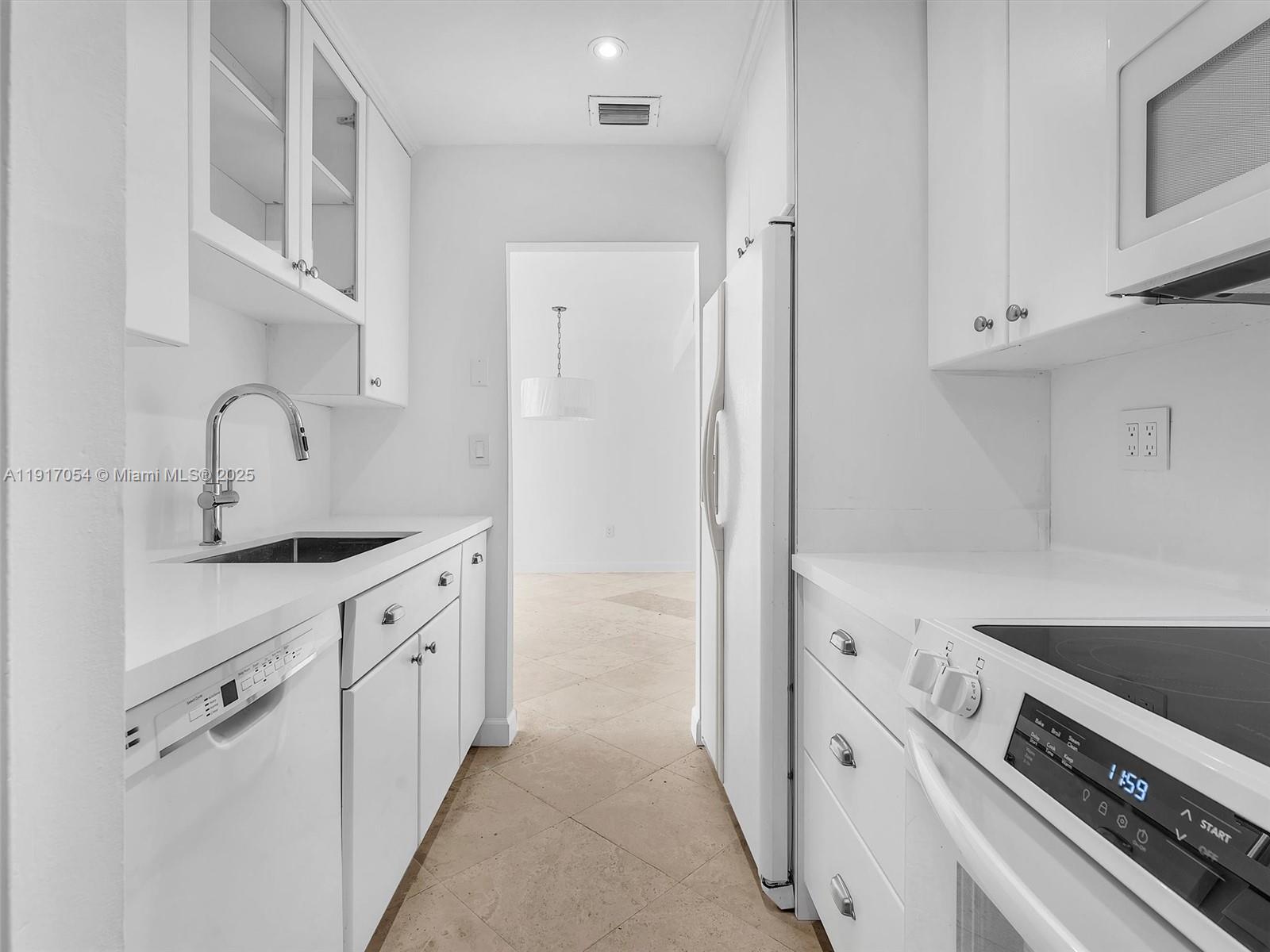 Key Biscayne Key Biscayne, FL 33149 - Photo 4 of 19 a kitchen with cabinets and a stove