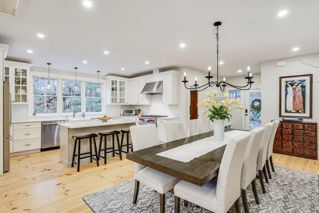 a kitchen with kitchen island a sink stove and refrigerator
