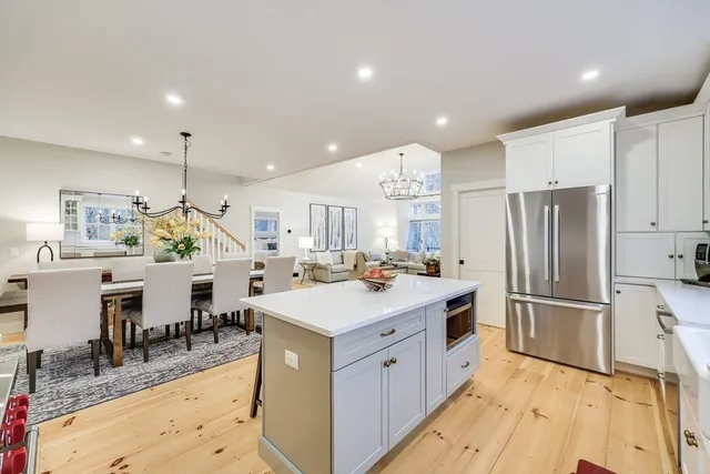 a bedroom with a large bed and a potted plant
