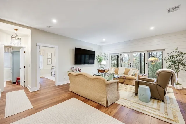 a living room with furniture and wooden floor
