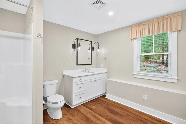 a bed room with a bed and a lamp