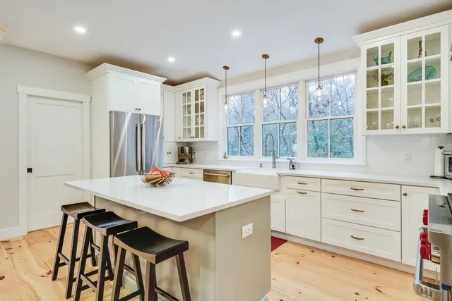 a kitchen with a stove a sink and a refrigerator