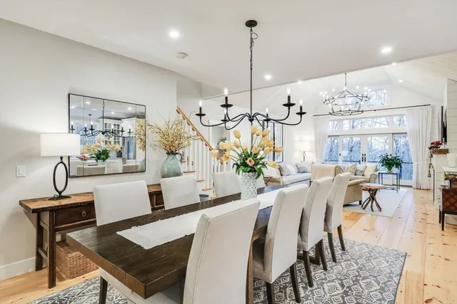 a living room with furniture fireplace and chandelier