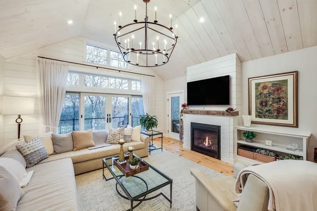 a living room with furniture a fireplace and a flat screen tv