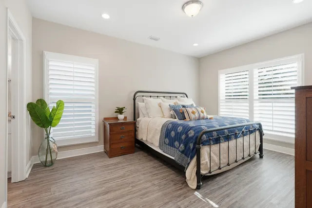 a bathroom with a granite countertop sink mirror and a toilet