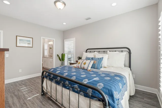 a bedroom with a bed and a potted plant