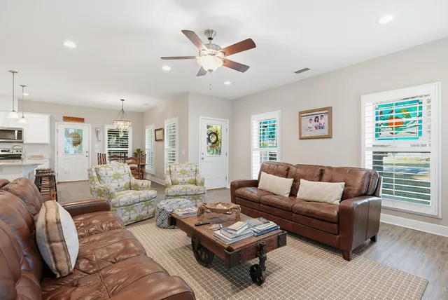 a kitchen with stainless steel appliances granite countertop a kitchen island a stove a table and chairs