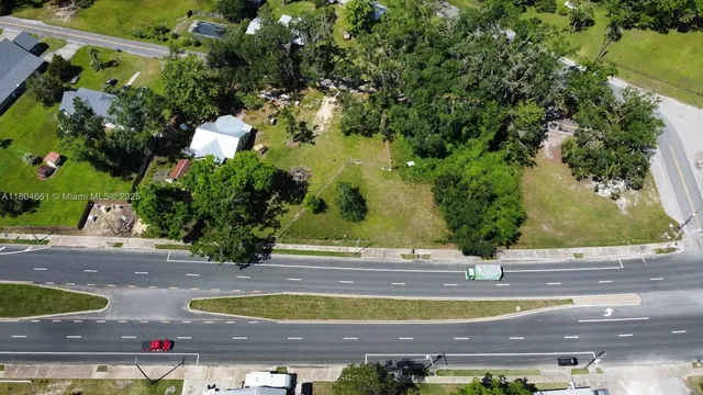 a view of a house with a yard and lake view