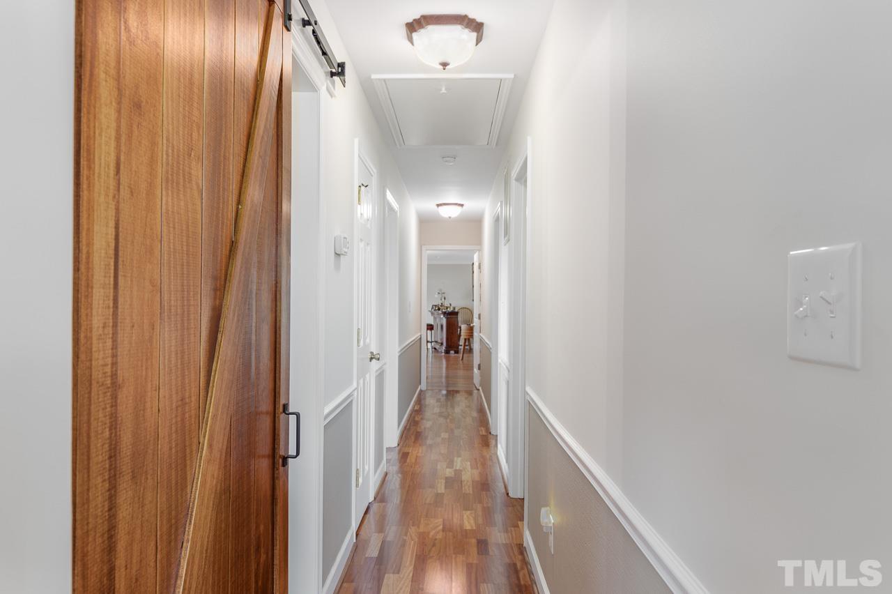 6668 Roby Coe Road Ramseur, NC 27316 - Photo 11 of 59 a view of a hallway with wooden floor