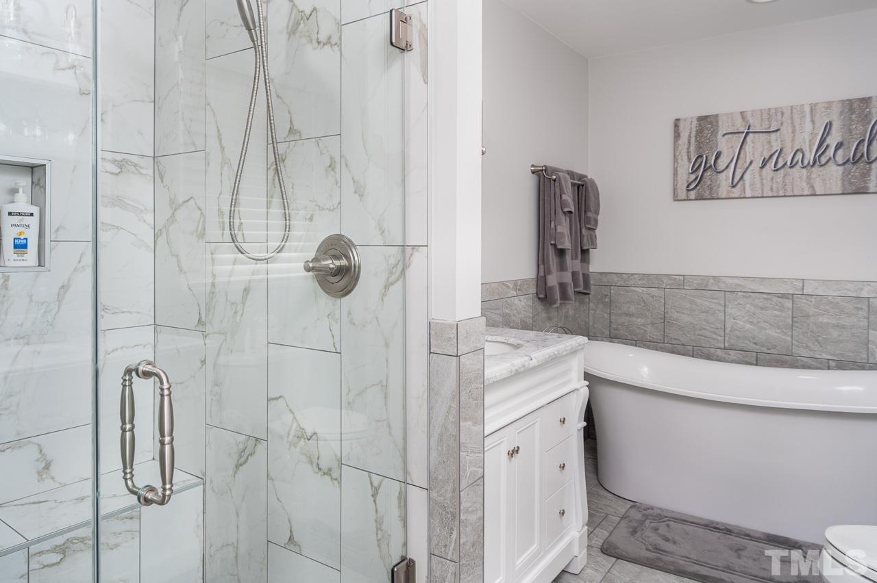 6668 Roby Coe Road Ramseur, NC 27316 - Photo 15 of 59 a bathroom with a granite countertop sink a toilet and shower