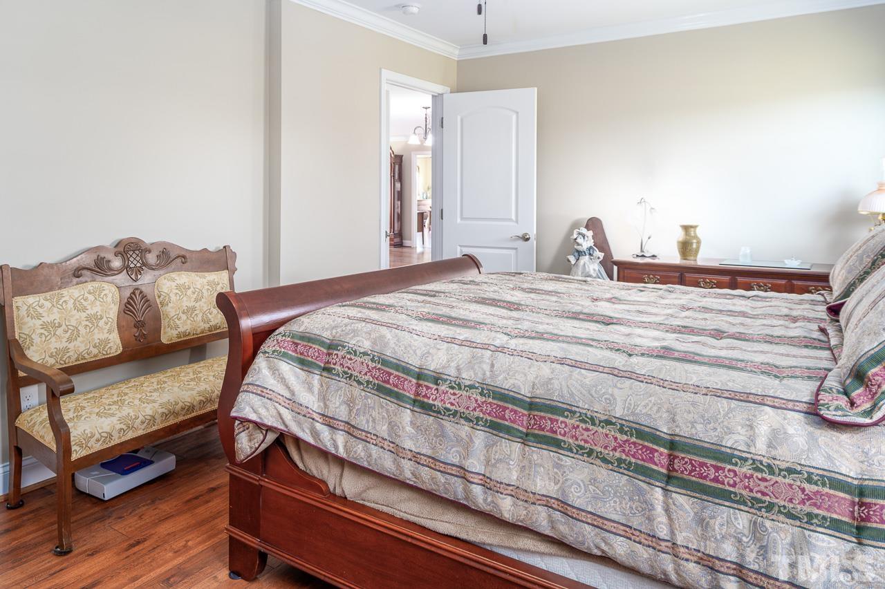 6668 Roby Coe Road Ramseur, NC 27316 - Photo 20 of 59 a bedroom with a bed and wooden floor