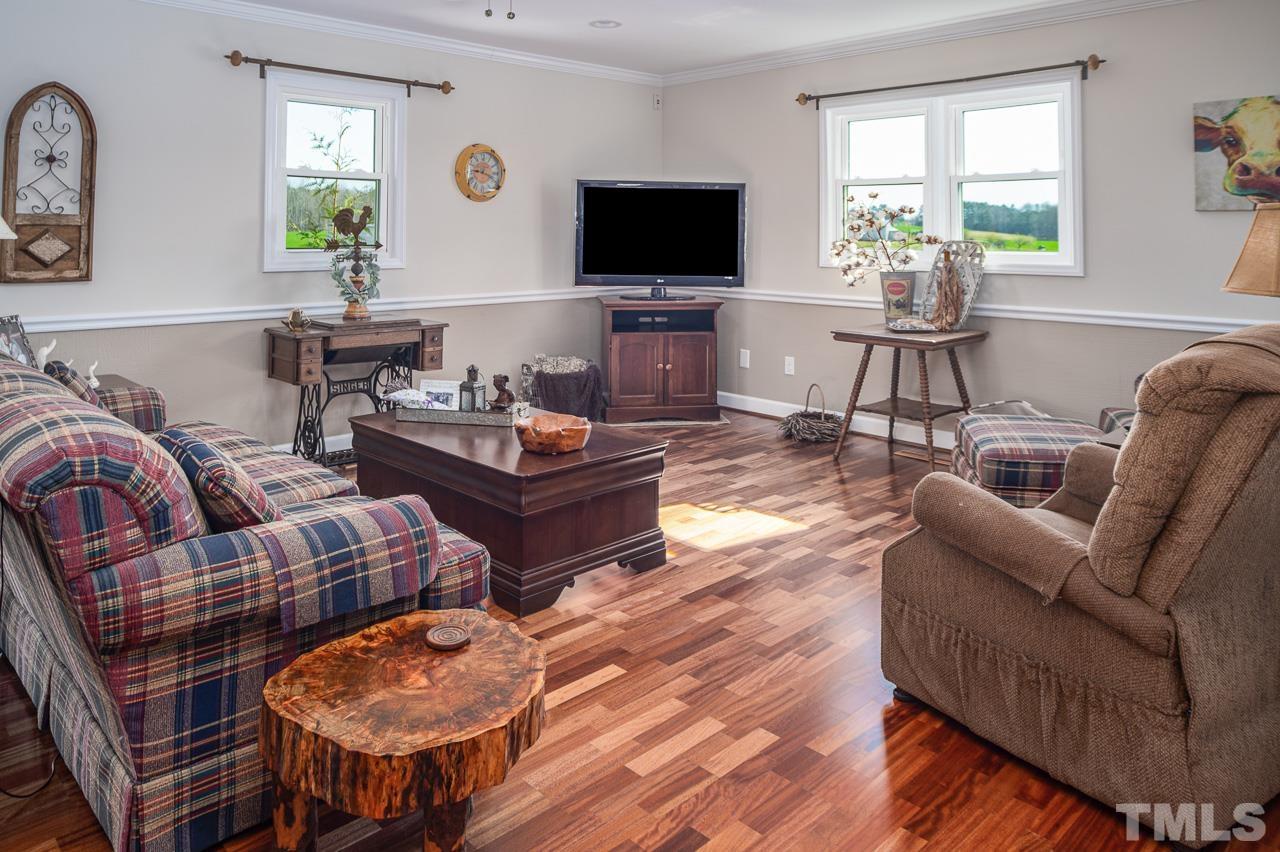 6668 Roby Coe Road Ramseur, NC 27316 - Photo 2 of 59 a living room with furniture a flat screen tv and a large window
