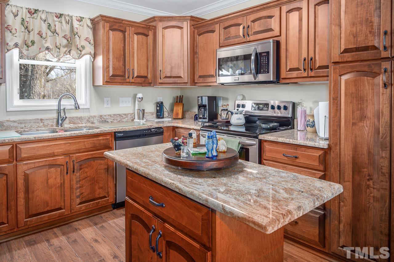 6668 Roby Coe Road Ramseur, NC 27316 - Photo 22 of 59 a kitchen with stainless steel appliances granite countertop a sink stove and cabinets