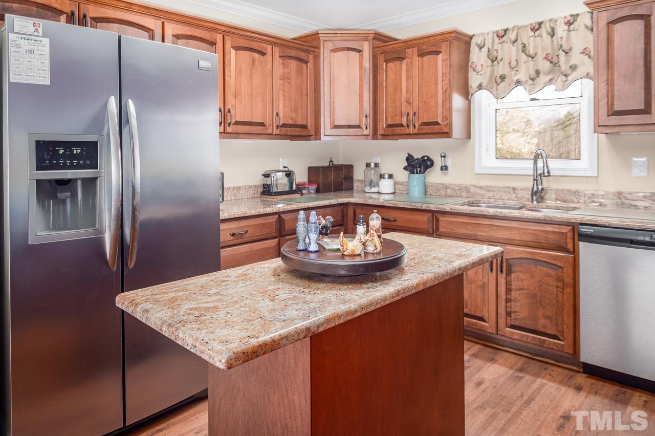 6668 Roby Coe Road Ramseur, NC 27316 - Photo 23 of 59 a kitchen with stainless steel appliances granite countertop a sink stove and refrigerator