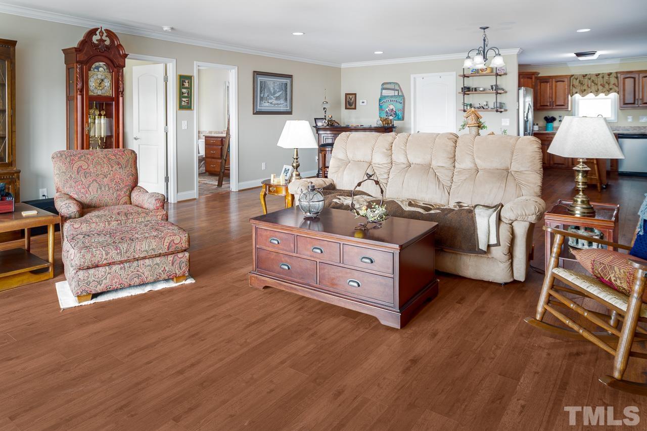 6668 Roby Coe Road Ramseur, NC 27316 - Photo 26 of 59 a living room with furniture and a wooden floor