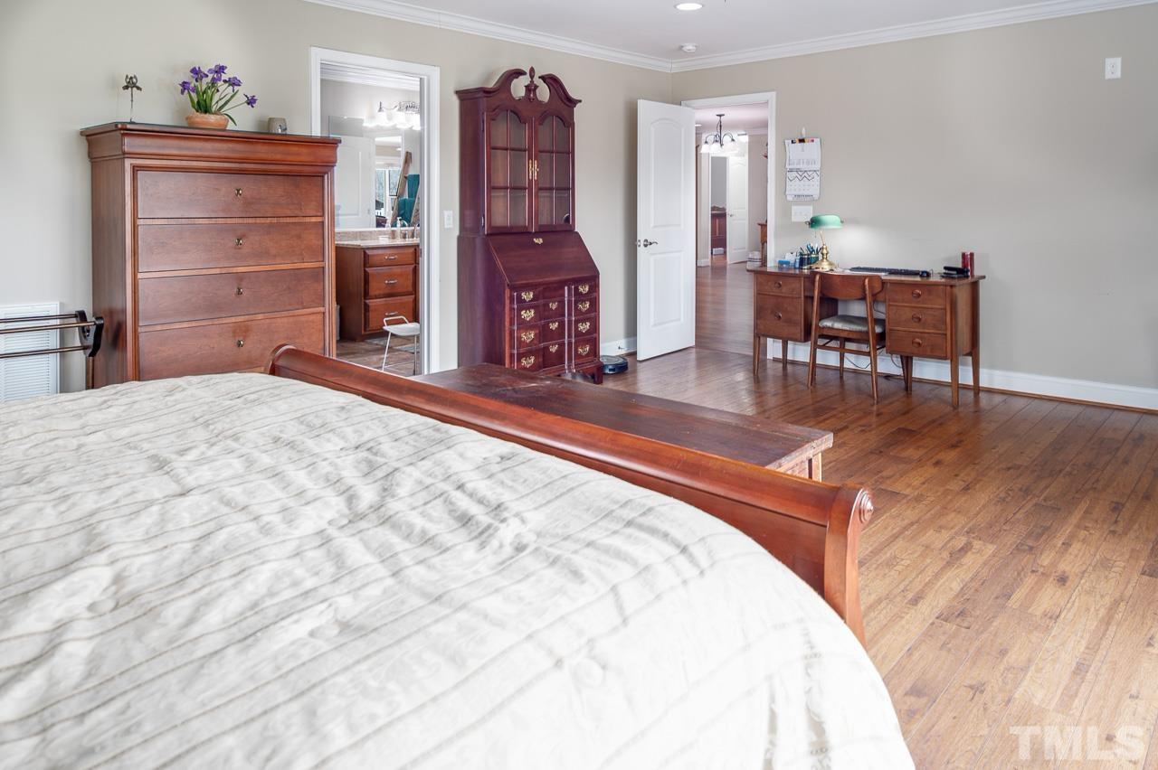 6668 Roby Coe Road Ramseur, NC 27316 - Photo 28 of 59 a spacious bedroom with a bed and a dresser in it