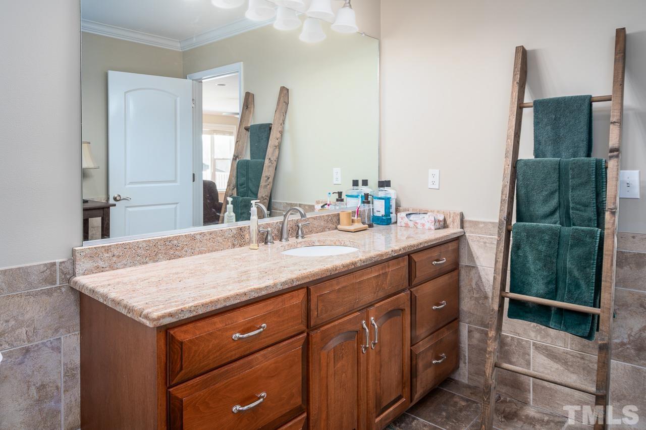 6668 Roby Coe Road Ramseur, NC 27316 - Photo 29 of 59 a bathroom with a sink vanity granite and a mirror