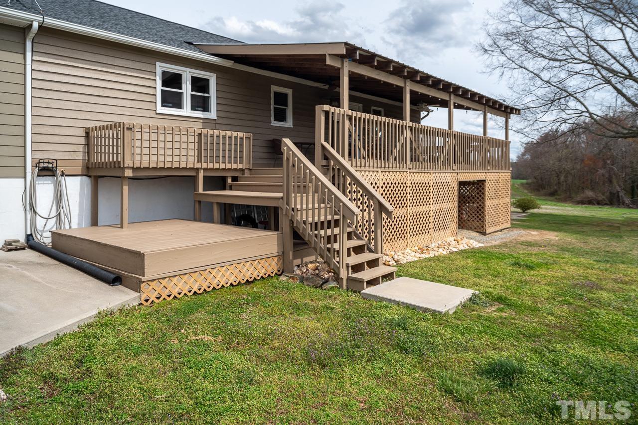 6668 Roby Coe Road Ramseur, NC 27316 - Photo 46 of 59 a view of a house with a yard and a wooden deck