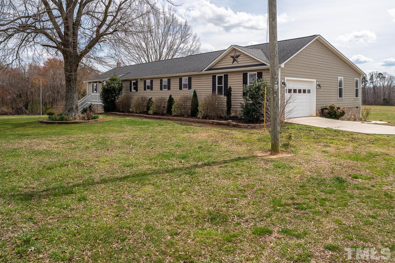 6668 Roby Coe Road Ramseur, NC 27316 - Photo 58 of 59 a view of a yard in front of a house with large tree
