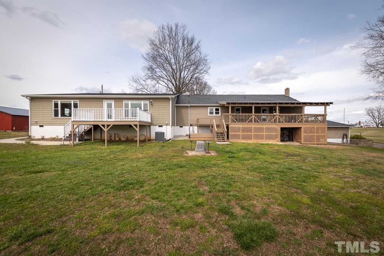 6668 Roby Coe Road Ramseur, NC 27316 - Photo 59 of 59 a backyard of a house with table and chairs