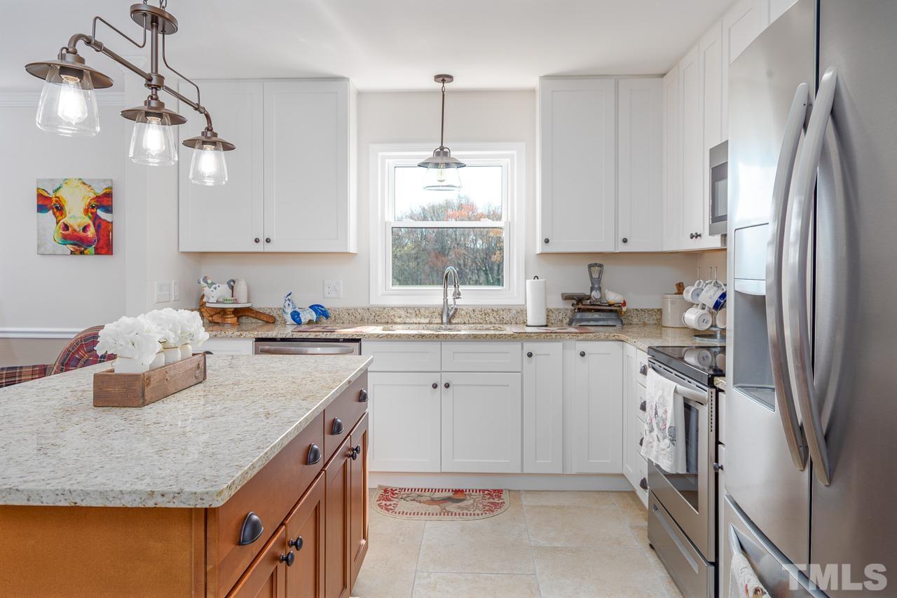 6668 Roby Coe Road Ramseur, NC 27316 - Photo 8 of 59 a kitchen with stainless steel appliances granite countertop a sink refrigerator and cabinets