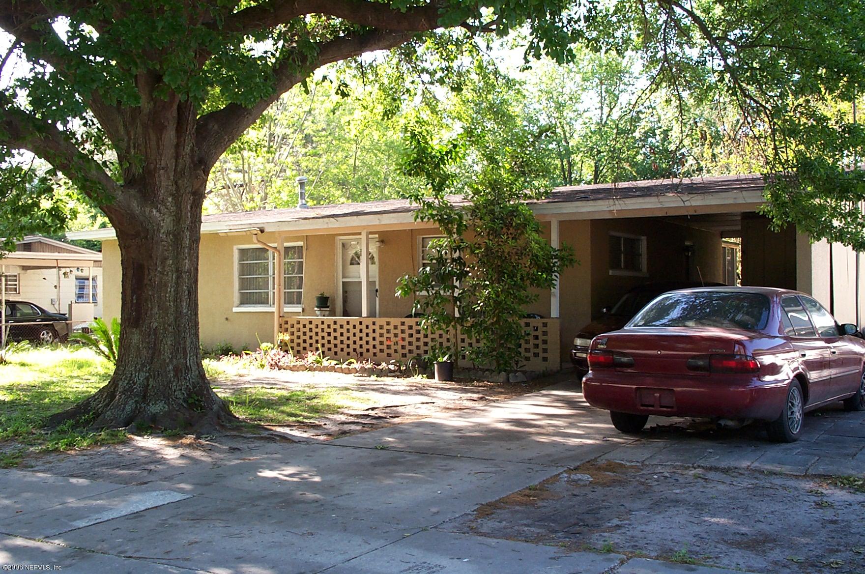 7336 Strato Road Jacksonville, FL 32210 - Photo 1 of 2 a front view of a house with garden space and trees