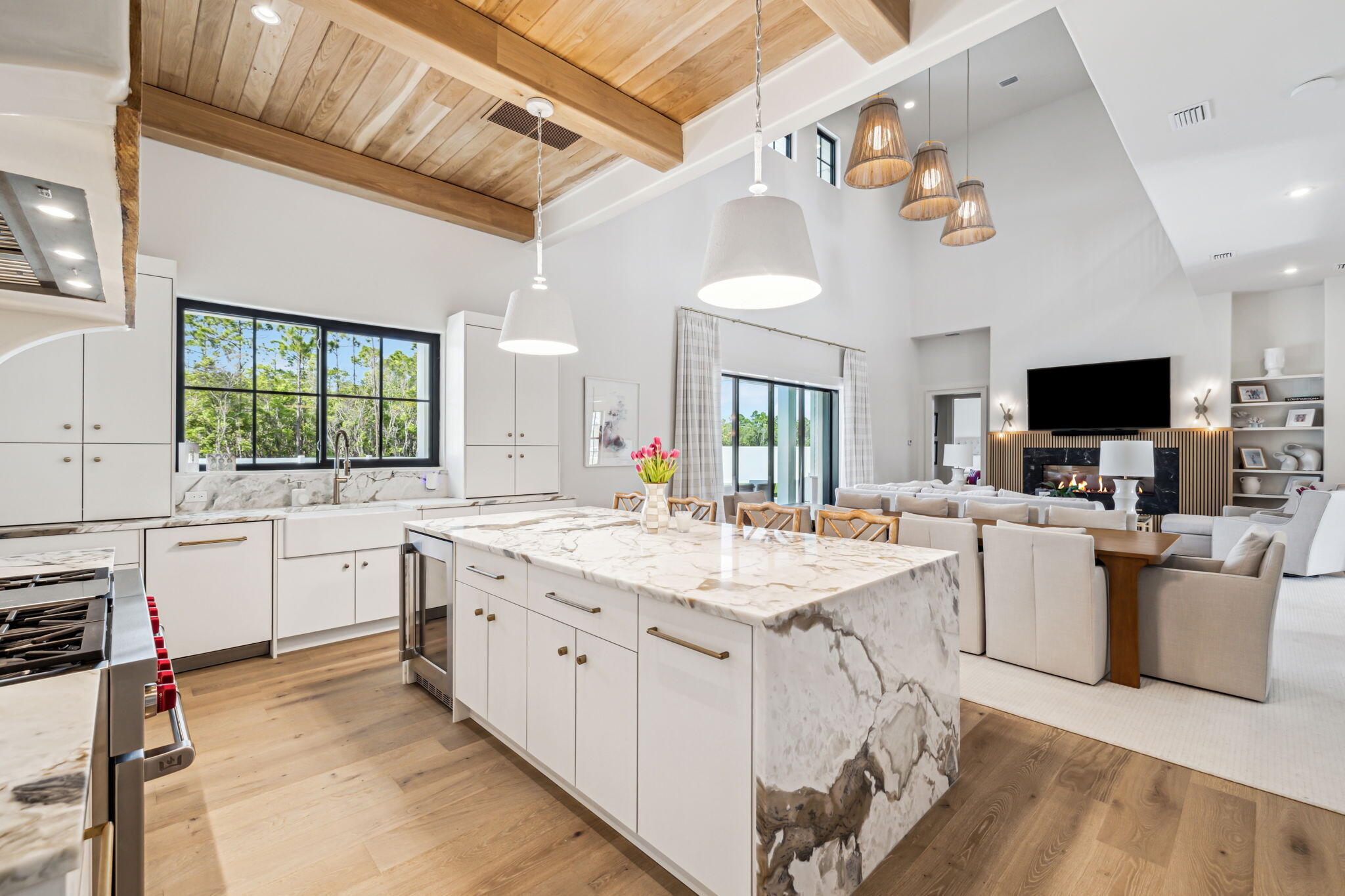 11 Sundew Pl Inlet Beach Inlet Beach, FL 32461 - Photo 12 of 51 a large white kitchen with a stove a sink dishwasher and a fireplace with wooden floor