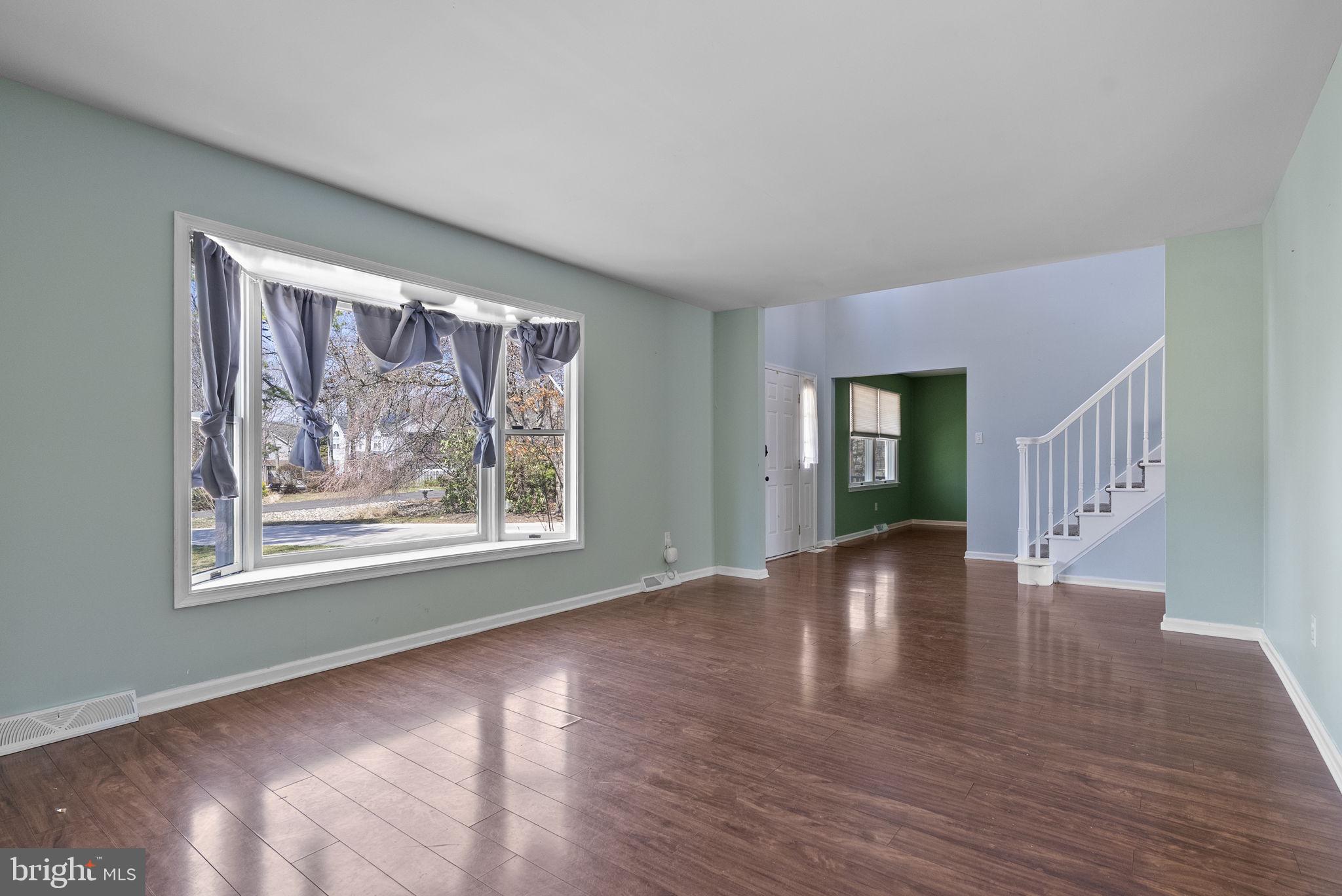 218 Crestview Avenue Absecon, NJ 08205 - Photo 13 of 67 a view of an empty room with wooden floor and a window